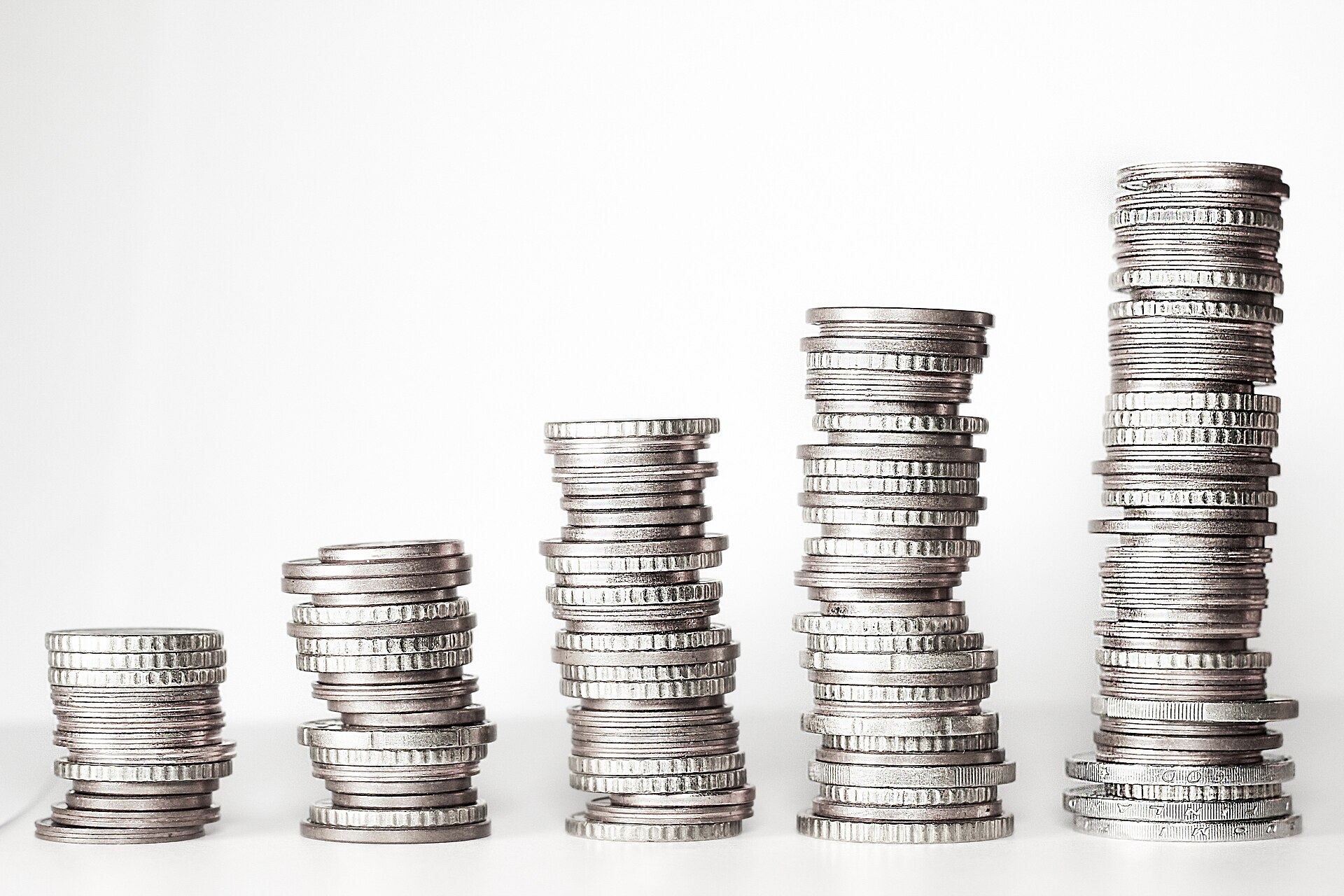 Stacks of old coins, including silver coins, for sale to a Burbank coin dealer